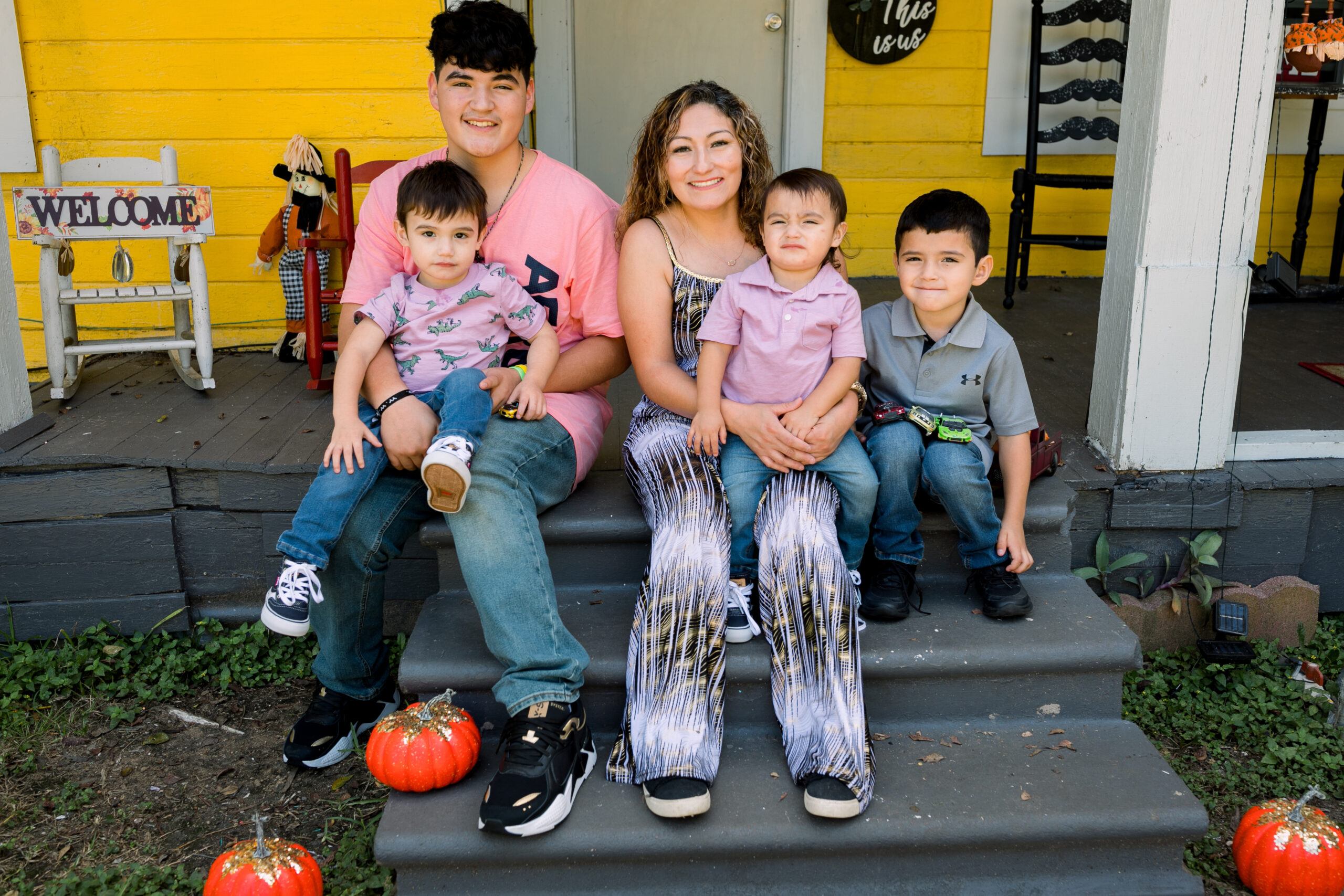A smiling family sitting together, illustrating our commitment to helping families thrive.